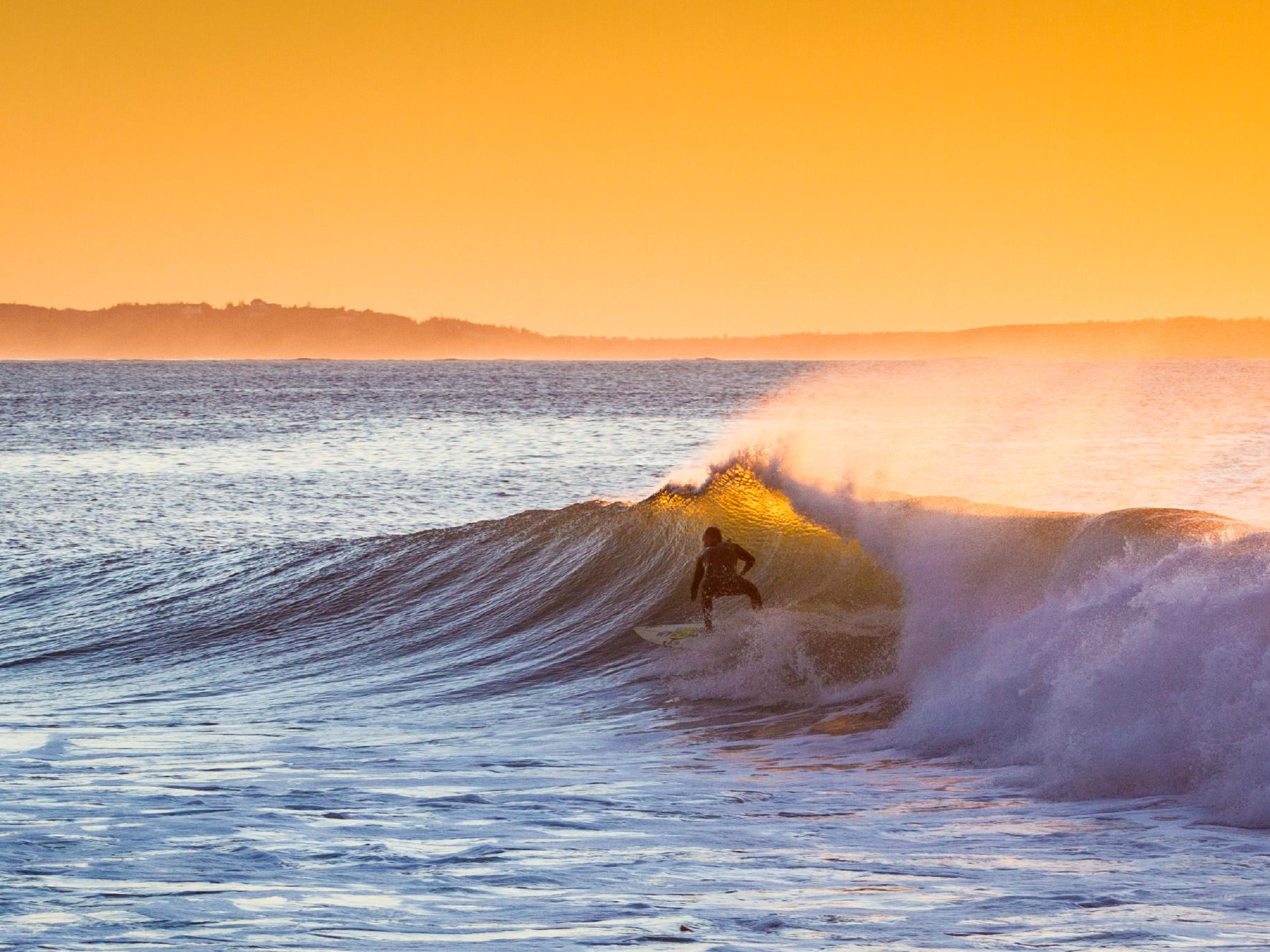 Surfer riding inside a breaking wave, Nova Scotia